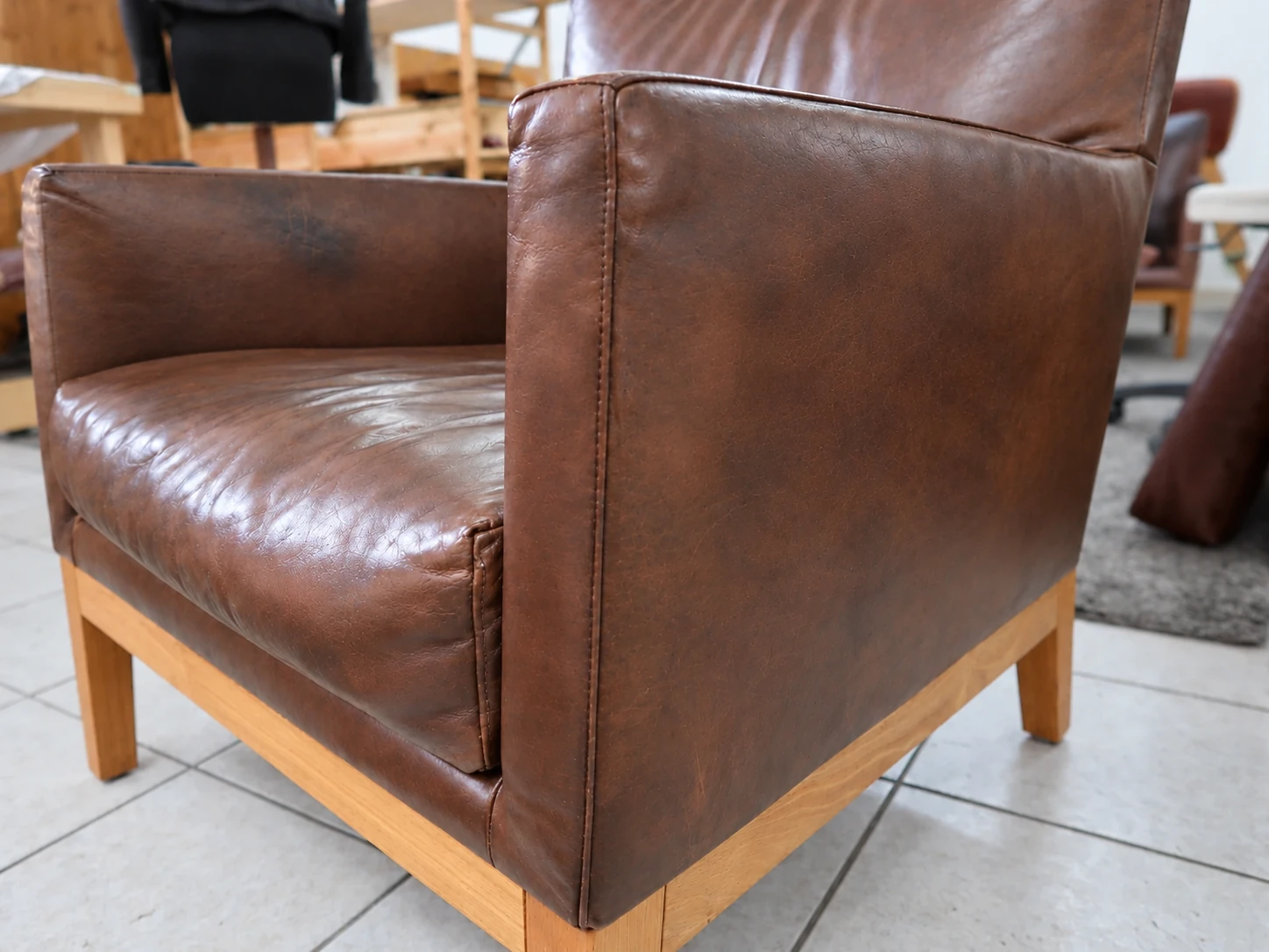 Aniline leather armchair after care, with the camera perspective digitally matched to the before photograph