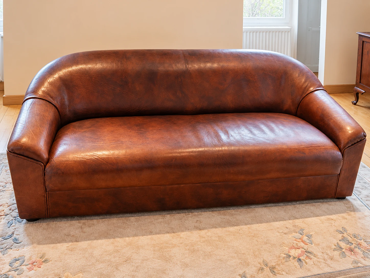 Brown buffalo leather sofa with rounded armrests