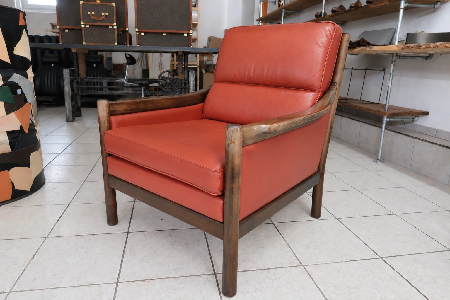 Restored coral-red leather armchair with the camera perspective matched to the before photograph using AI assistance